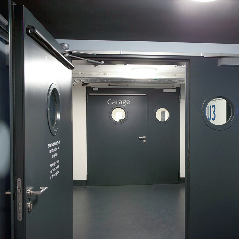 A Pair Of Double Steel Fire Doors Protecting A Car Park Access Corridor