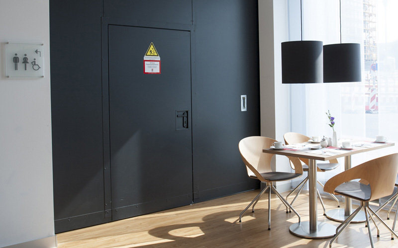 Fire-resistant sliding door EI2 90 „Teckentrup 62 FST“ Dividing A Hotel Space With Inset Pass Door