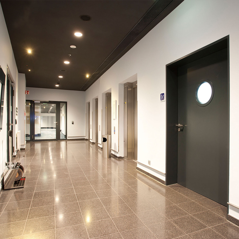 Insulation and Integrity Certified Steel Fire Door Protecting A Stairwell And An All-Glass Fire Door Protecting The Corridor l